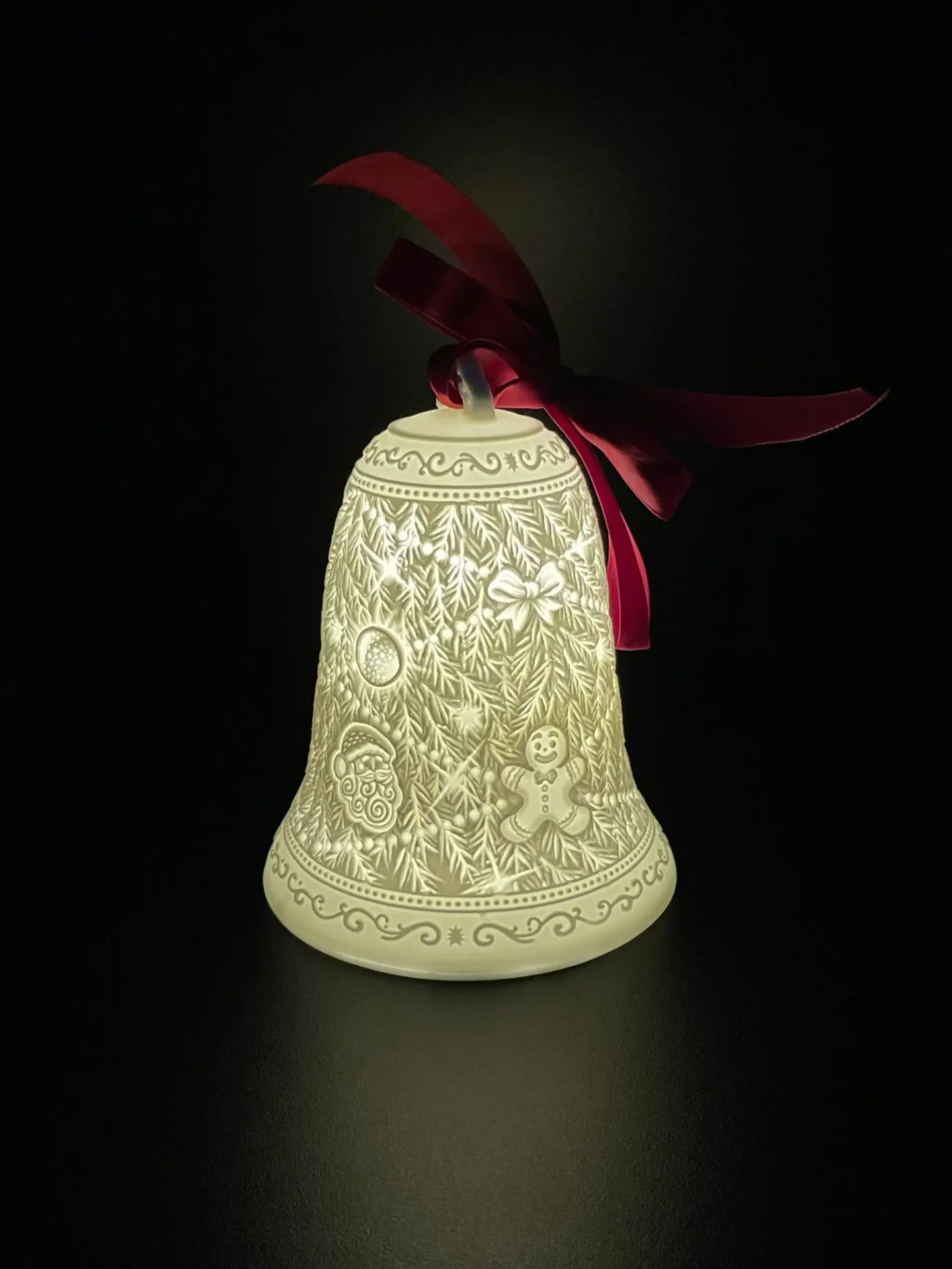 A bell with a red bow on it