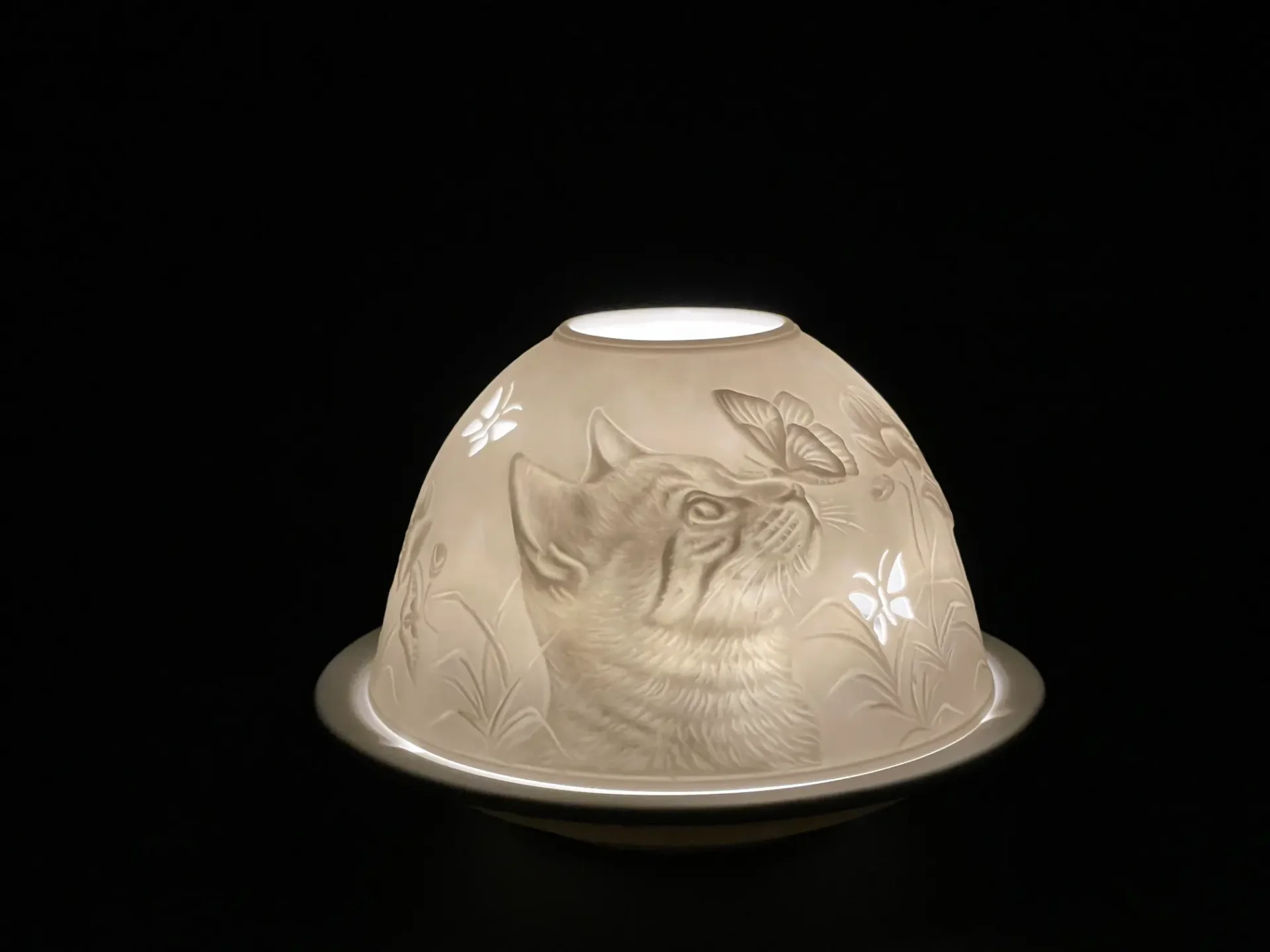 A candle holder with a dog on it