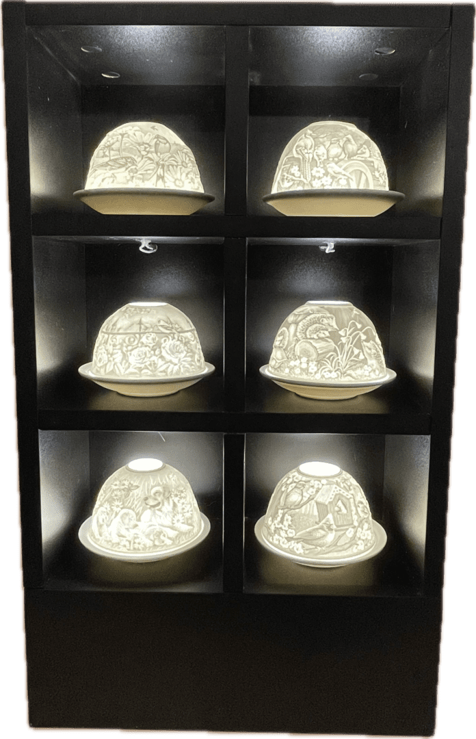 A shelf with six different lamps in it.