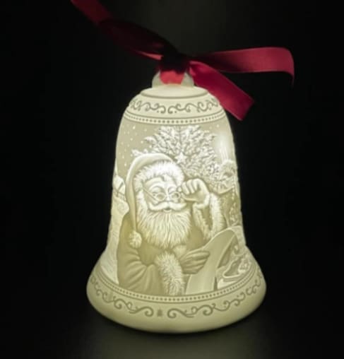 A lighted bell with santa claus on it.